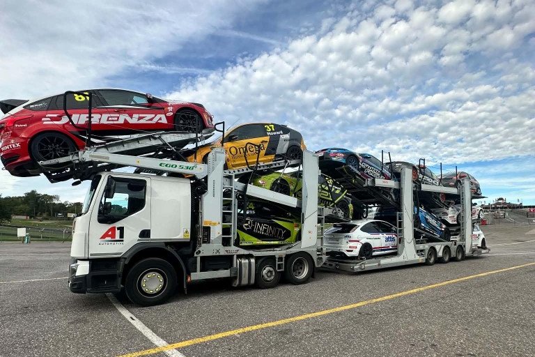 A1 Automotive transporter on a circuit, loaded with touring cars